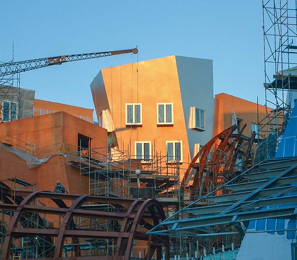 Sunrise glows over the Pisa building at MIT Stata Center during construction.