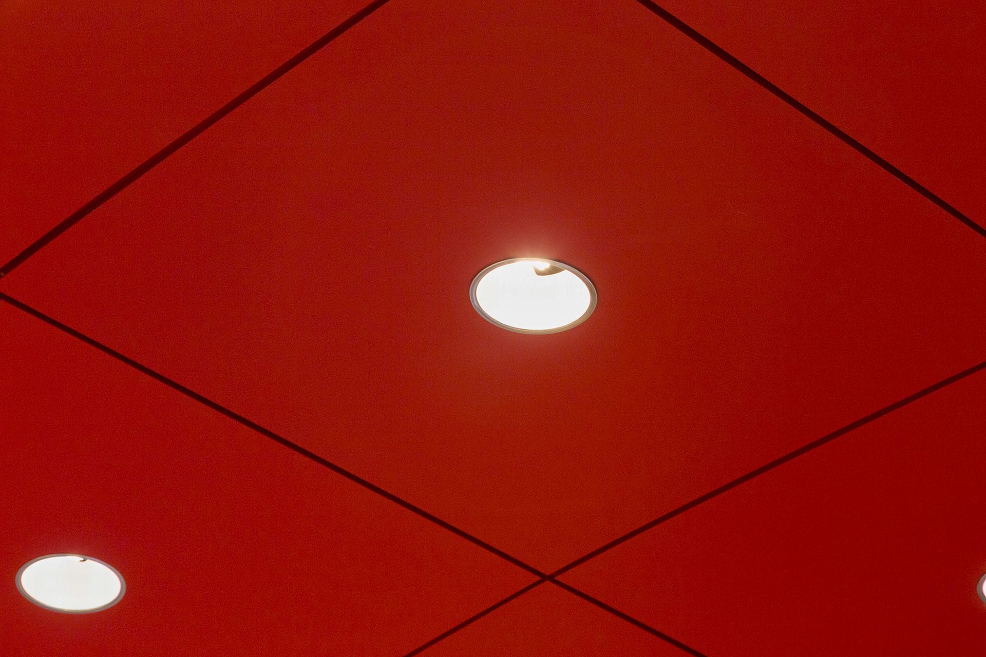 Detail of the recessed lighting system detailed in the aluminum canopy's interior ceiling panels.