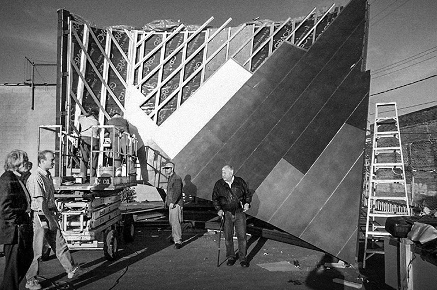History of Fisher Center: The Design Team looks at the dual curvature metal panel system at A. Zahner Company Headquarters | Bard College student sign 'Make huge silver crumpled buildings, not war.'