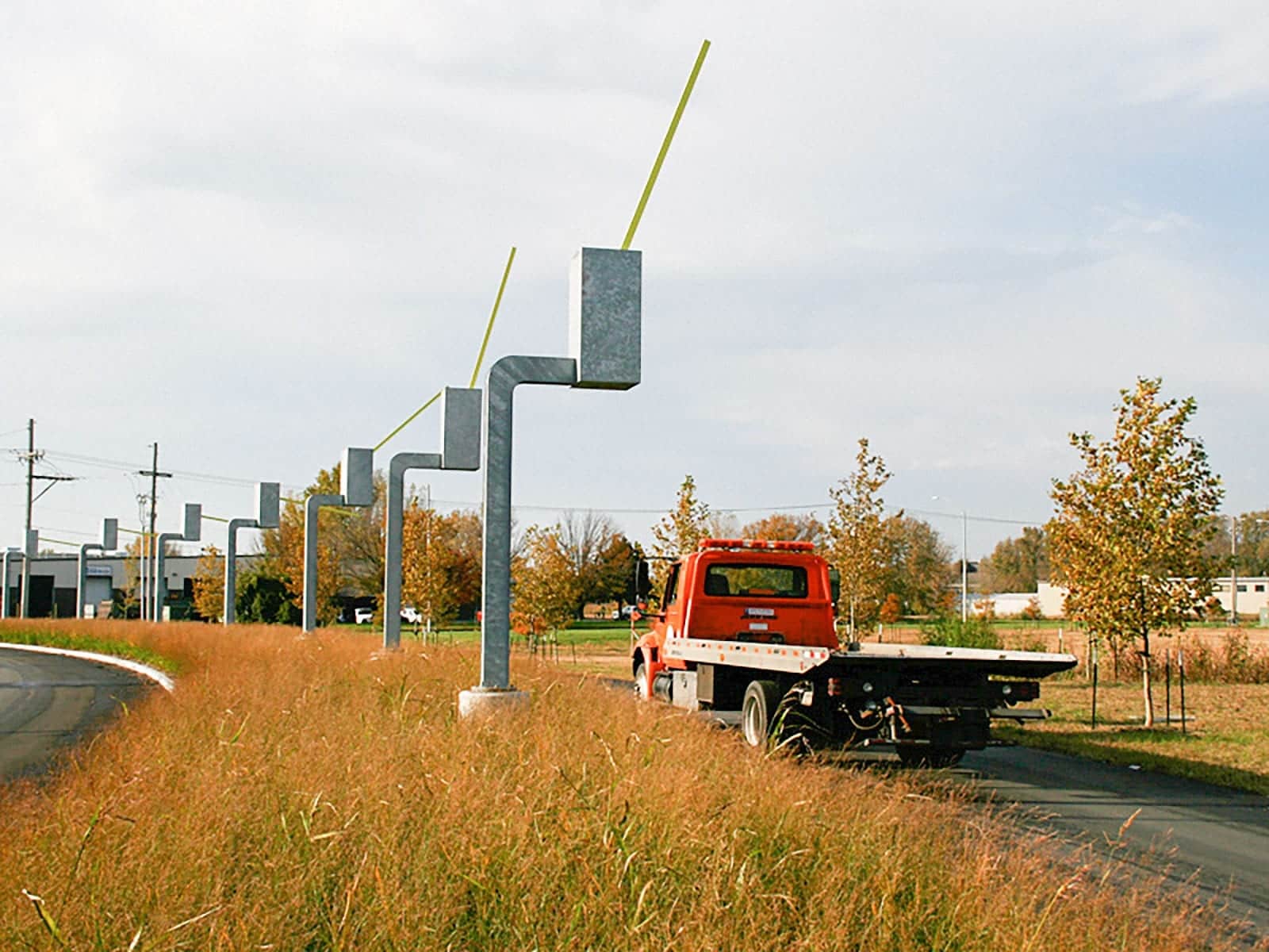 Seven Sentinels kinetic sculpture. Each of the parking gate sculptures salute exiting drivers.