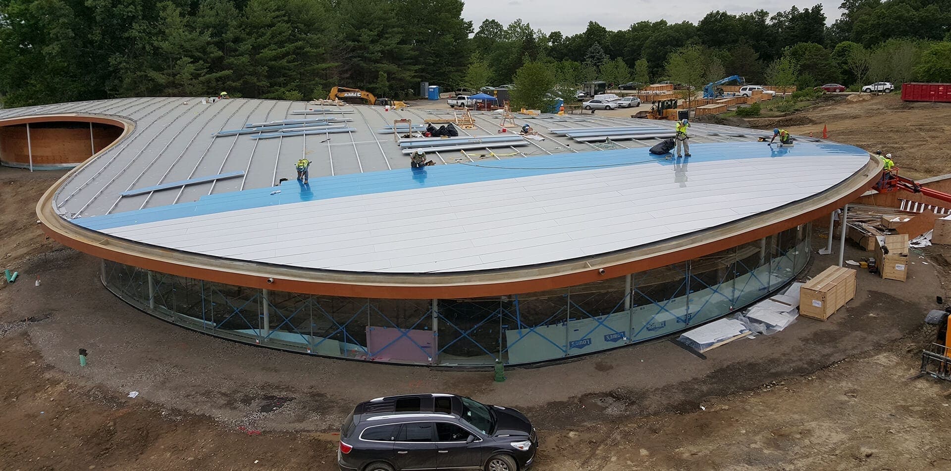 Installers lay the panels to create the dual curve roof on Grace Farms.