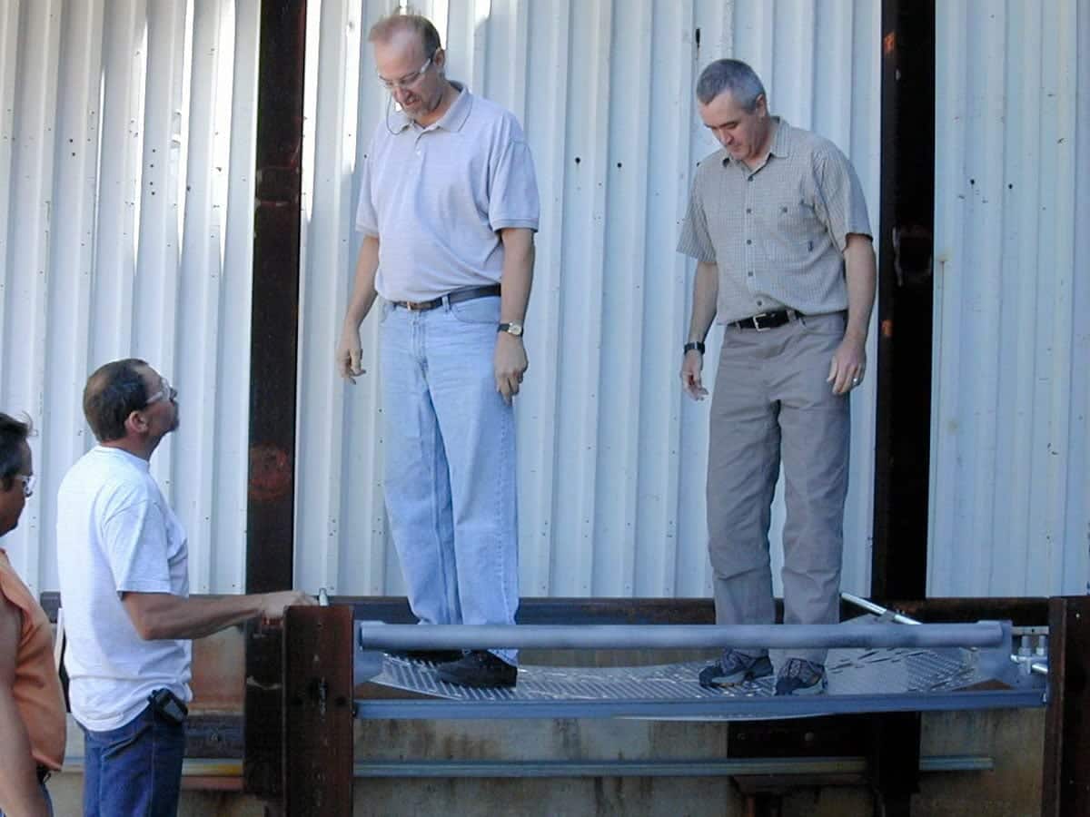 Zahner's Tony Birchler and Wallace Engineering's Steve Huey test the structural load of the individual perforated panel mockup.
