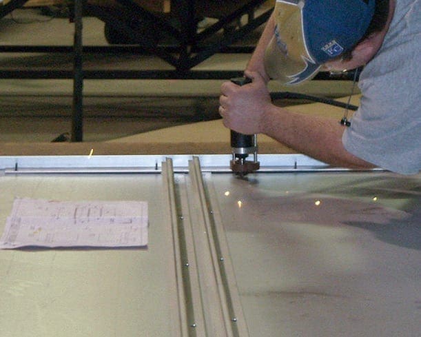Zahner fabricator installs studs on the backs of NS11 Panels.