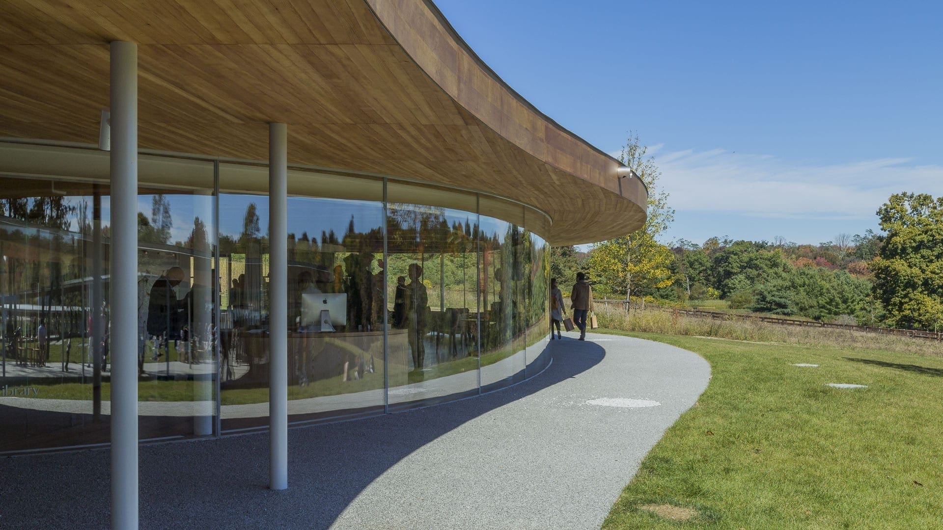 The building's wooden soffit provides a contrast to its reflective aluminum roof.