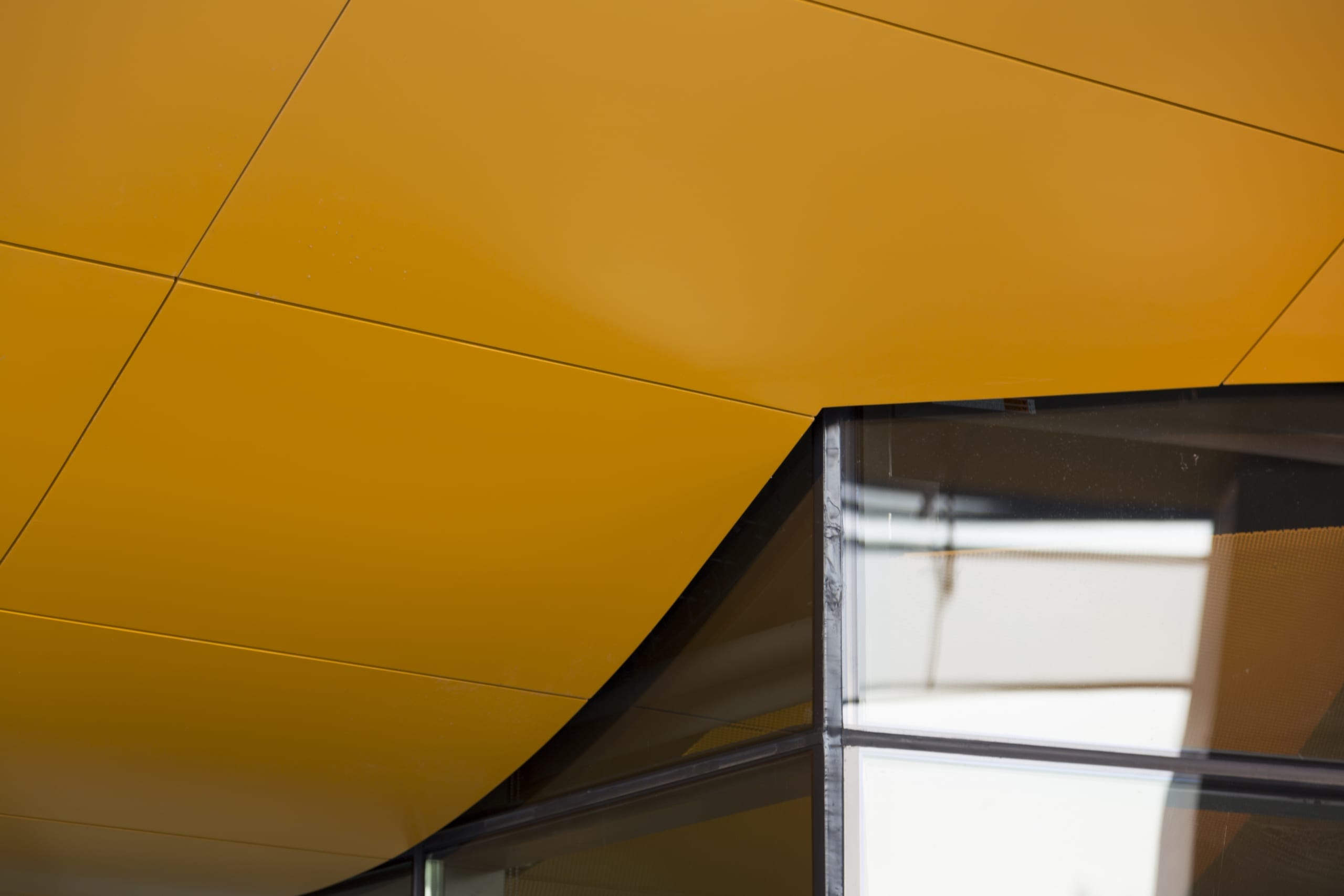 Detail of the orange-painted aluminum soffit system used on Gates Hall at Cornell University.