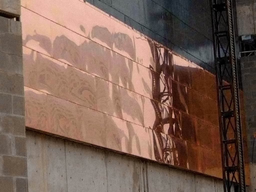 installation of raw copper panels at Freedom Center.