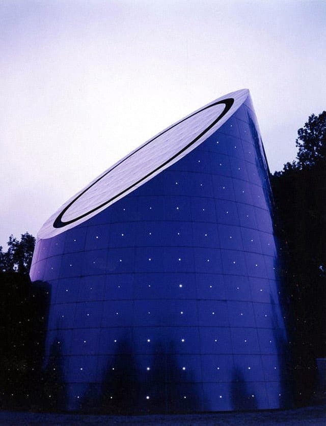 Small lights dot the exterior surface