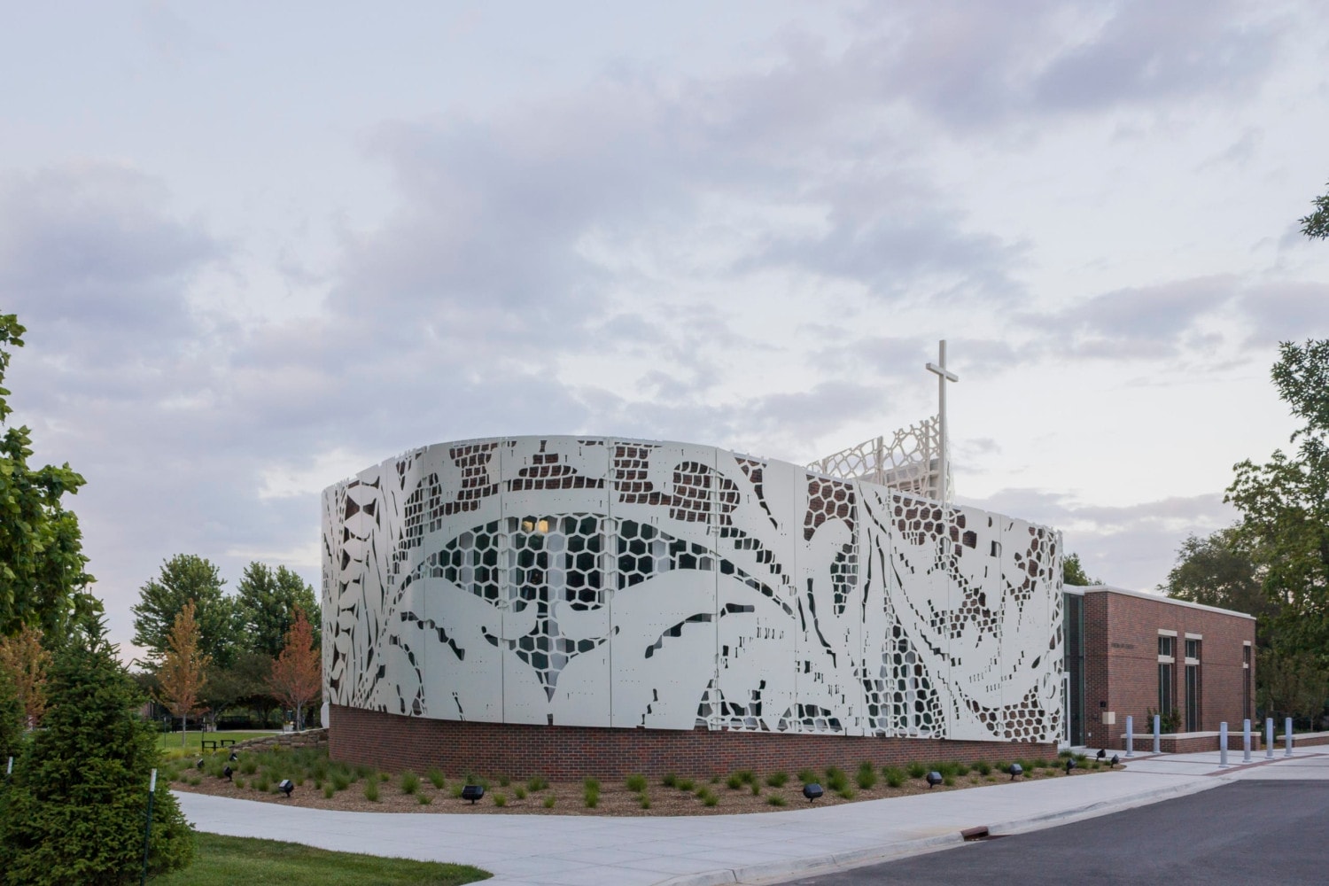Lace patterns cut into plate aluminum and rolled for the curving facade at St. Teresa's Academy.