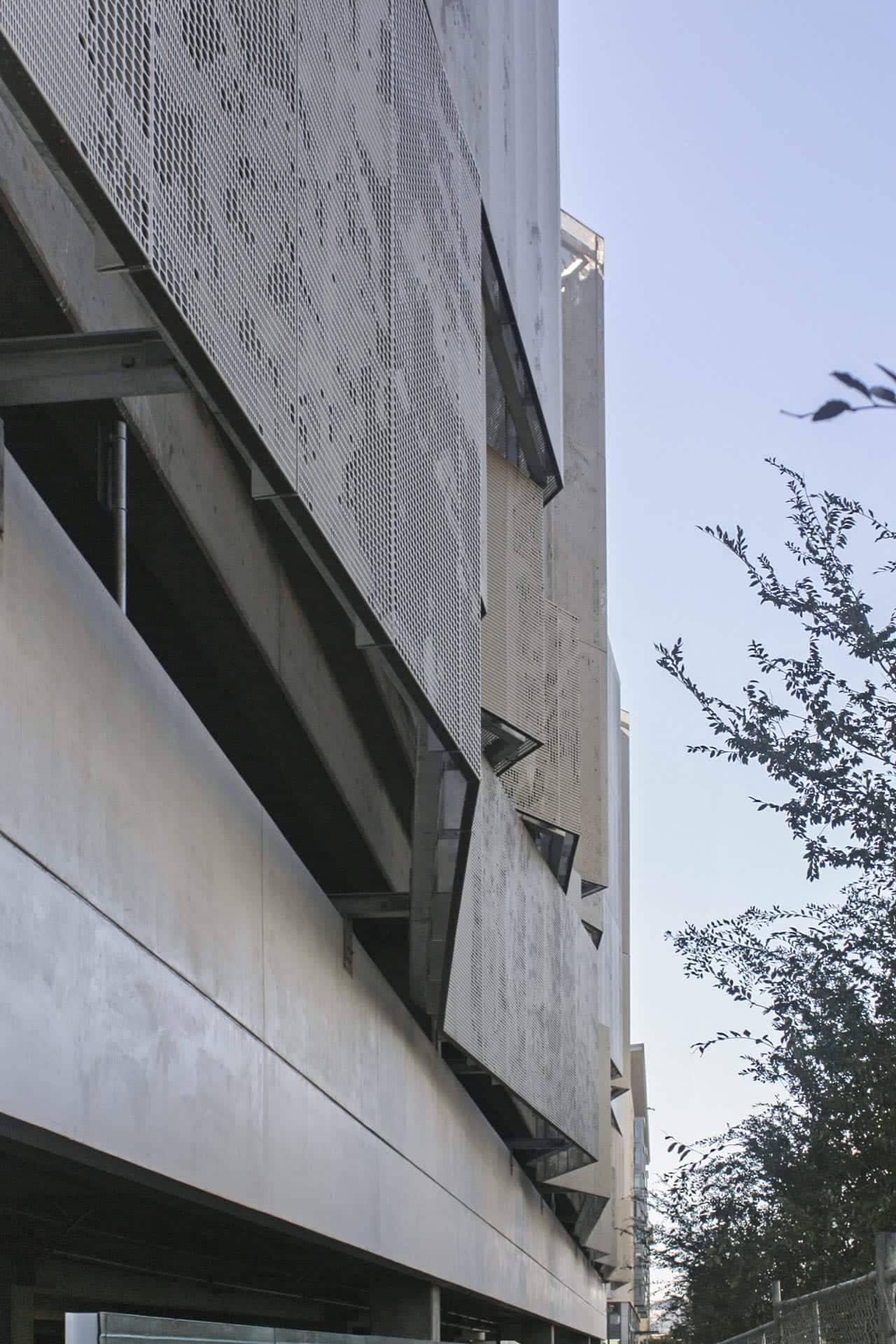 Detail of the perforated zigzag aluminum system used to cool and ventilate the school's parking garage. 
