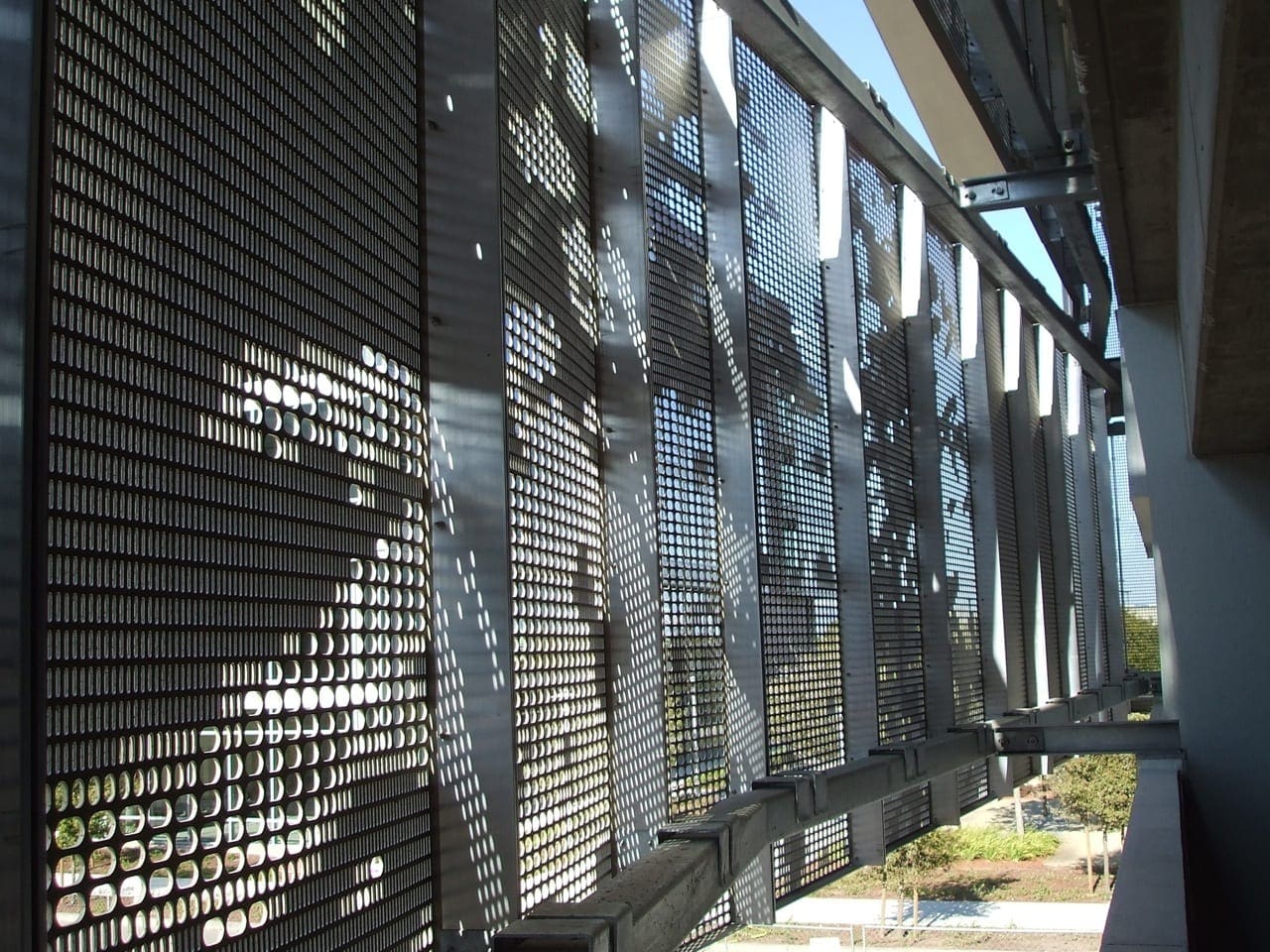 Detail of the perforated aluminum facade system from within the garage. 