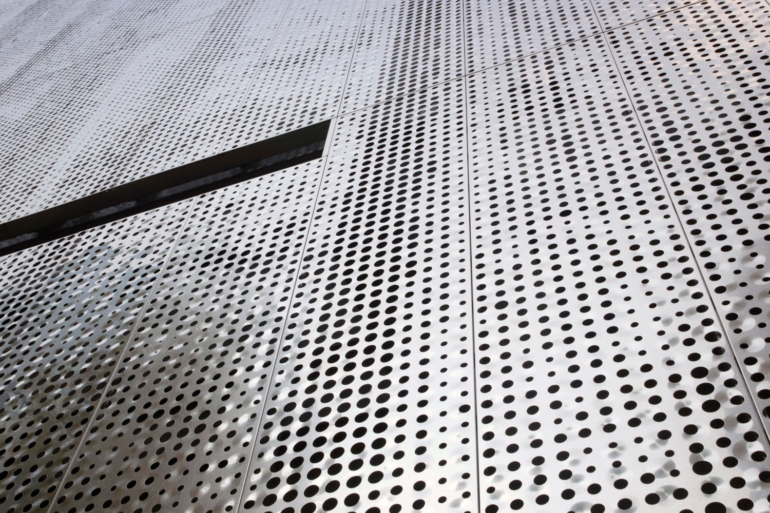 Detail of the custom perforated facade for Fairmont Pacific Rim.