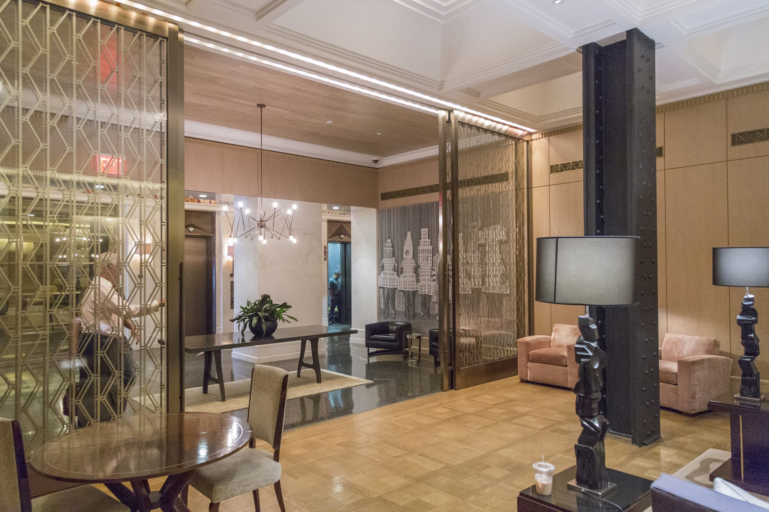 Custom interior glass sliding doors for the Walker Tower lobby. CUSTOM INTERIOR GLASS AND BRONZE SLIDING DOORS FOR THE WALKER TOWER LOBBY.