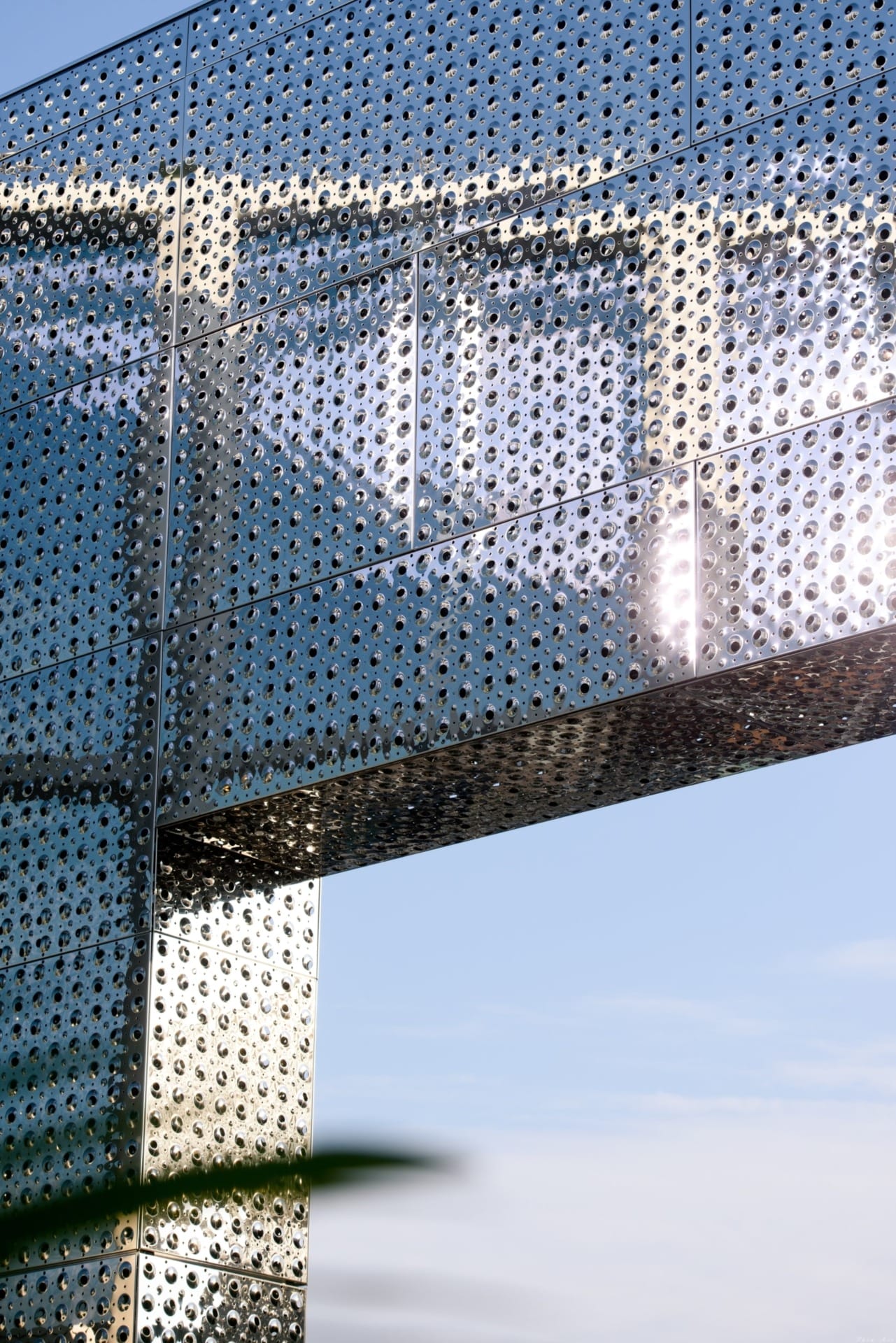 Detail of the custom perforated emboss used to bump and perf the stainless steel facade.