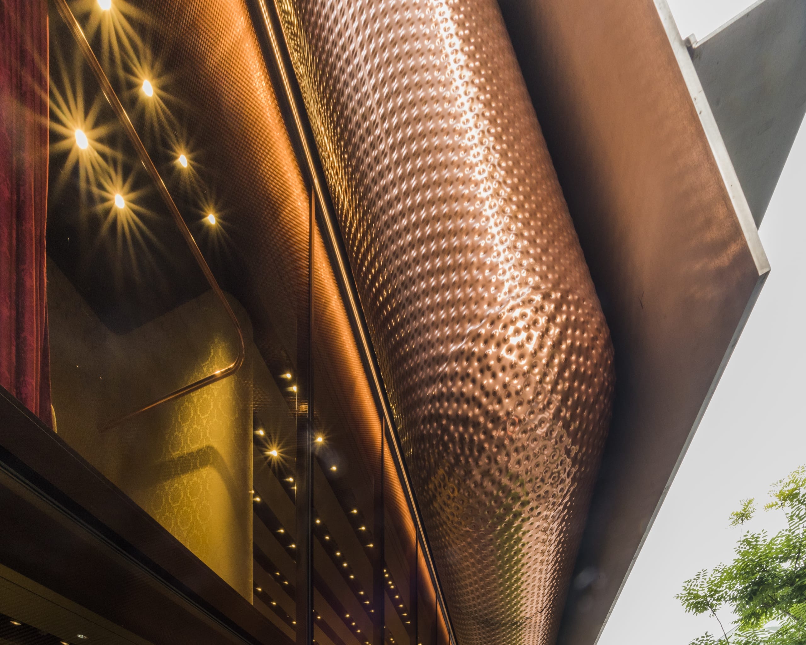 dense custom copper perforations on the Miu Miu Aoyama in Tokyo.