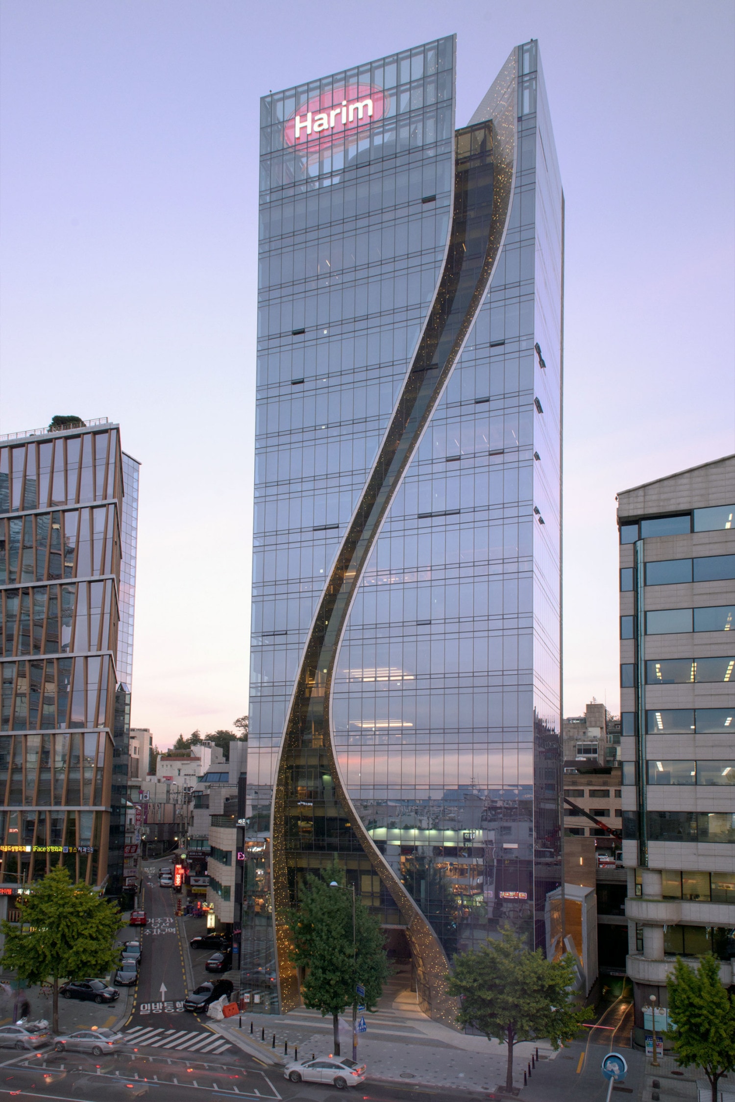 Curved metal 'S' shape facade of the Harim facade in stainless steel.