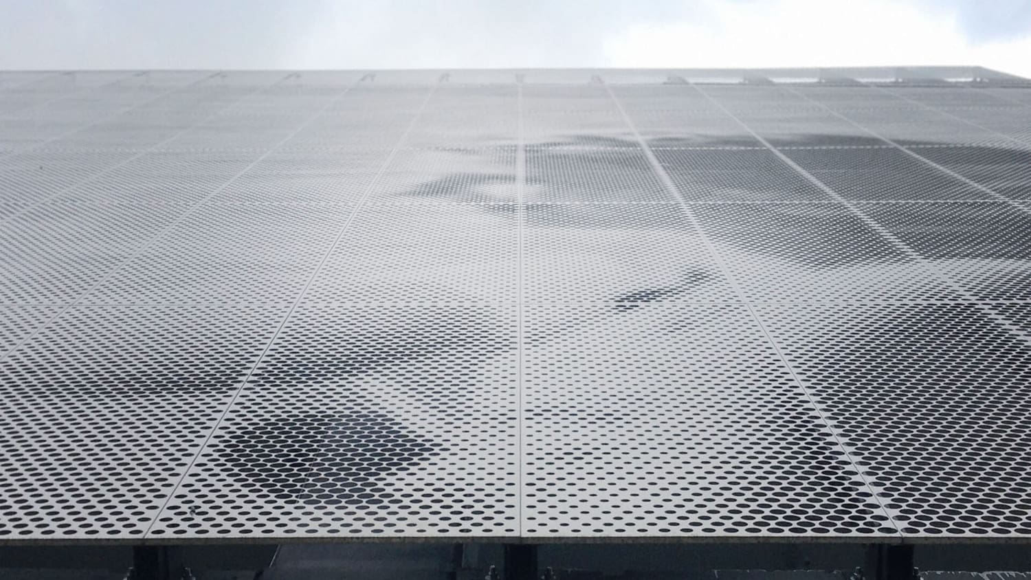 Parking garage facade designed by artist John Baldessari using ImageWall and Angel Hair Stainless Steel.