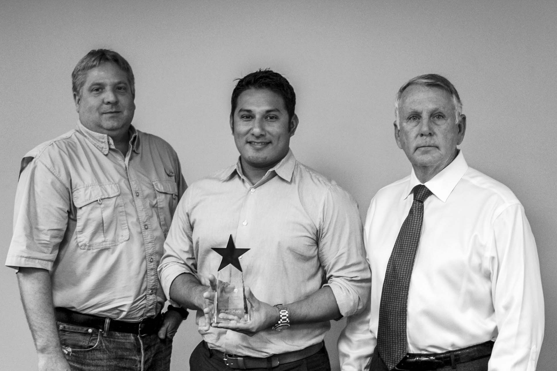 Tony Zuniga, Project Engineer (center), accepts the award for Pollution Prevention (P2) with Danny Jett, General Foreman (left), presented by Tom Cox, Deputy City Manager of Grand Prairie, Texas.