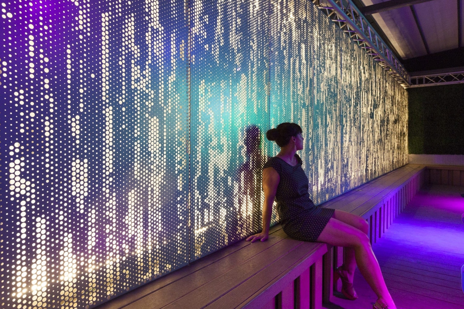An illuminated ImageWall screen provides a dramatic backdrop for an event space