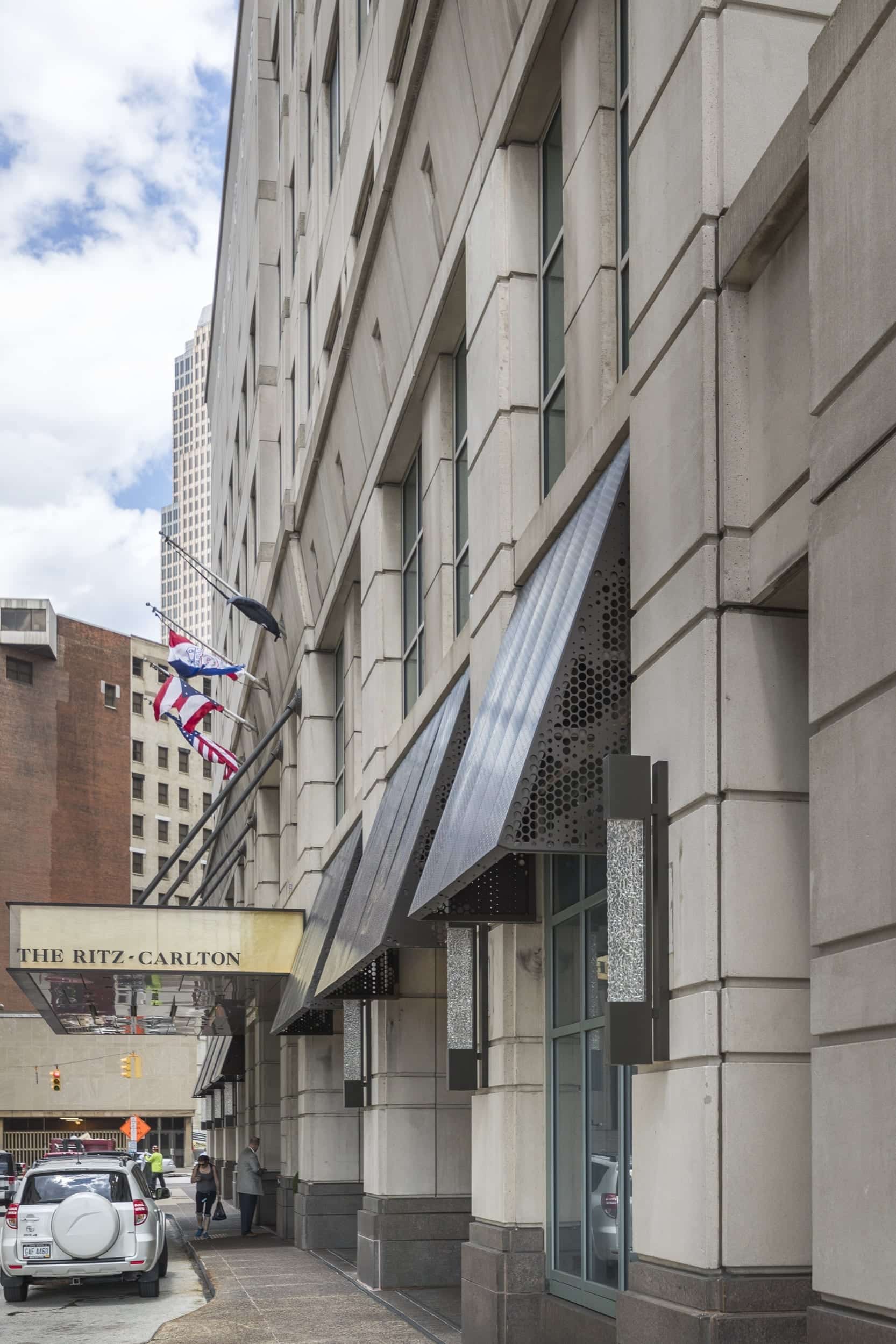 ritz-cleveland-c-tyler-wick-zahner-7756 Anodized aluminum panels and structure for a series of awnings. Raised circles on the front create a pattern while still protecting from the elements.