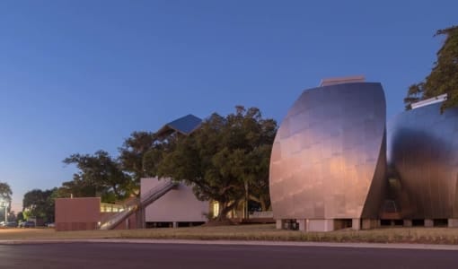 OHR O'KEEFE MUSEUM AT DUSK, FEATURING ANGEL HAIR STAINLESS STEEL AND ZEPPS TECHNOLOGY.