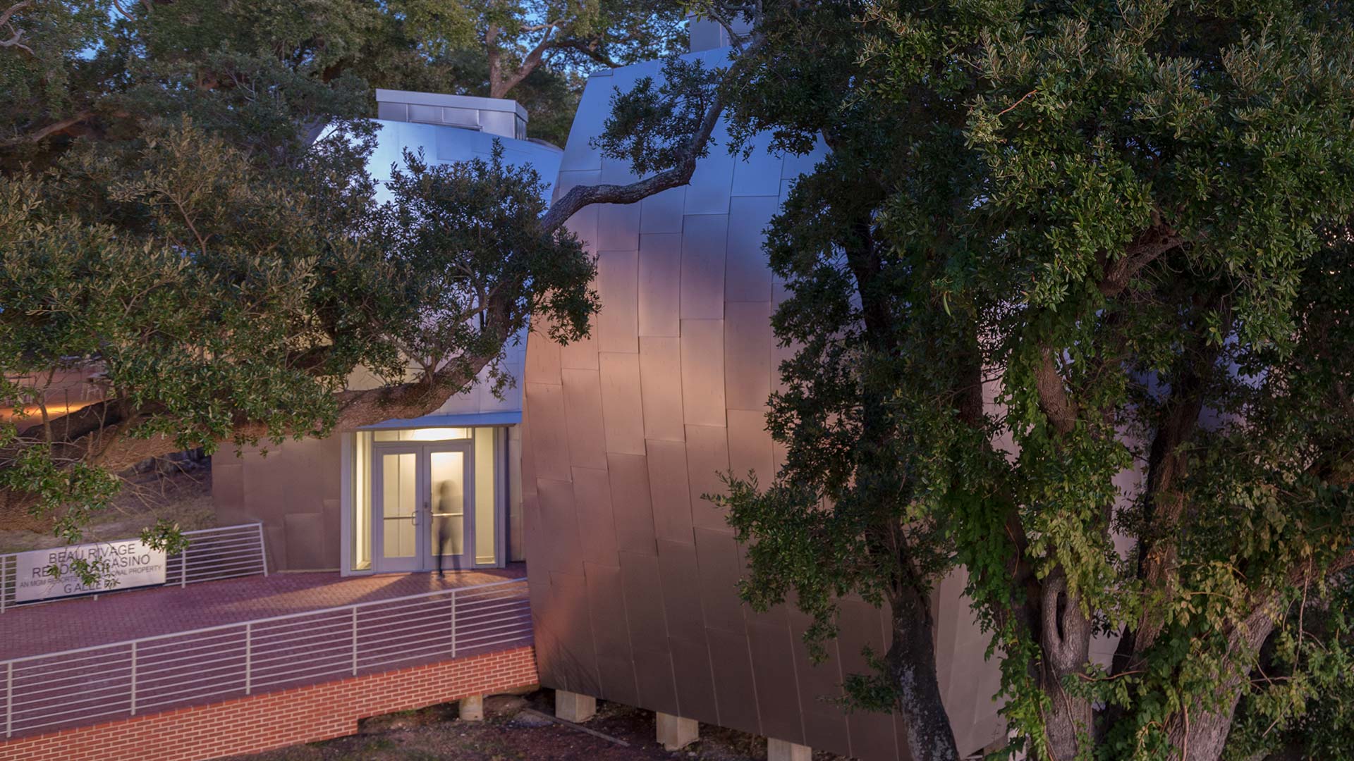 AMBIENT REFLECTIVITY OF THE ANGEL HAIR STAINLESS STEEL PANELS BY ZAHNER FOR THE OHR-O'KEEFE MUSEUM OF ART.