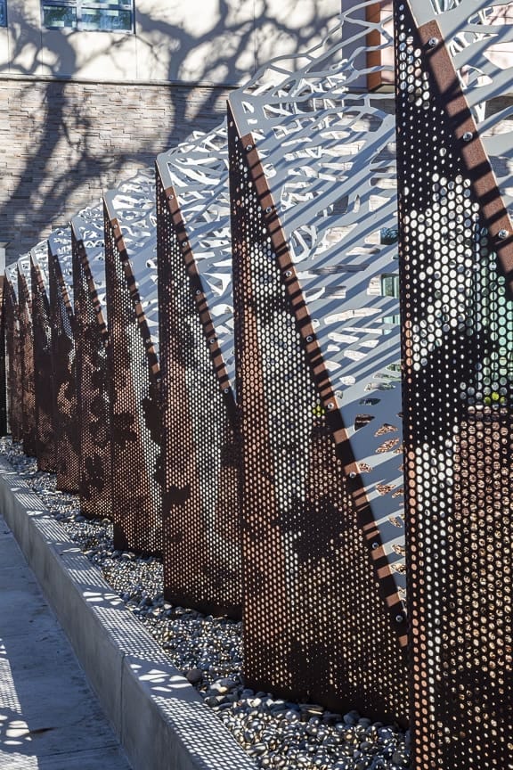 170180_Walnut Creek Folding Fence (12) The leaves pattern on the Solanum panels was created using our ImageWall® custom-perforation technology.
