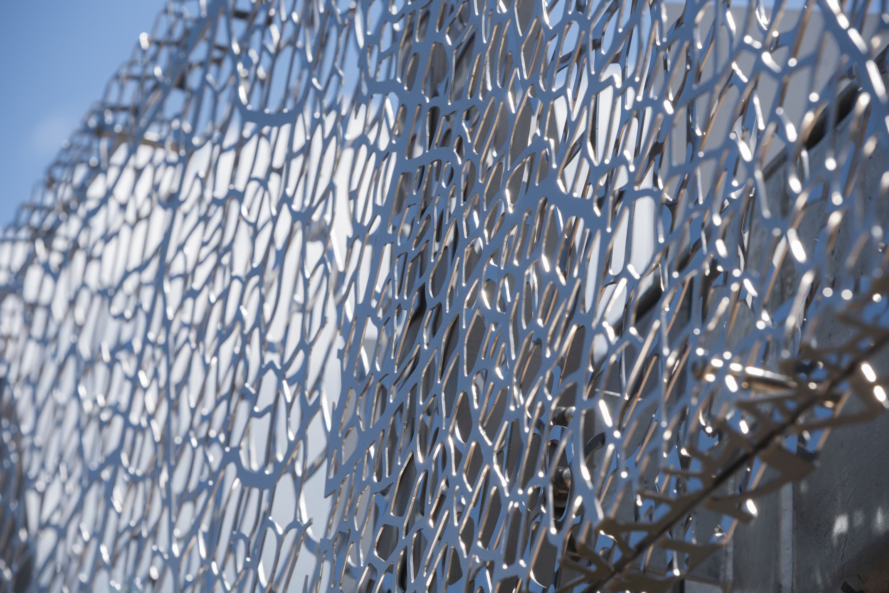 Closeup of the lazer-cut stainless steel art screen for 2100 L Street.