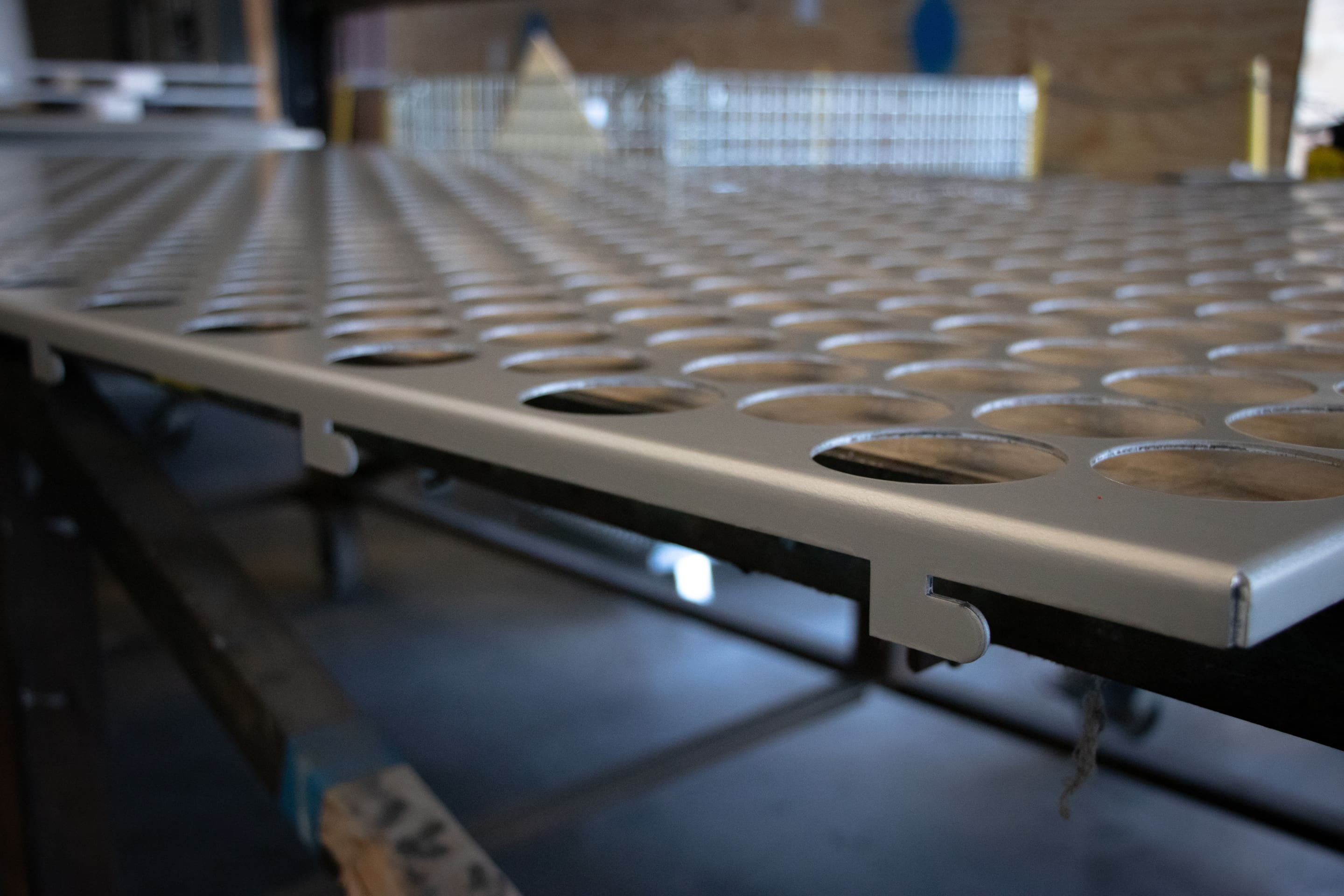 Closeup of male attachment tag on perforated panel.