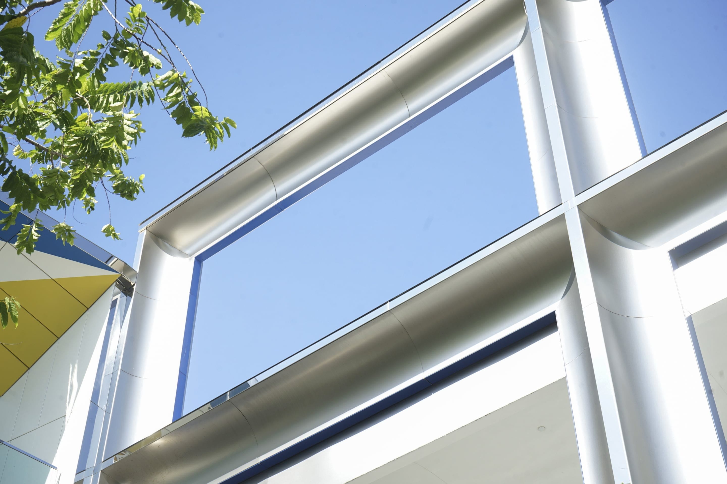 The Johnston Marklee design features silver mirror-polish stainless steel trim, Zahner Angel Hair cladding, and blue stainless steel window trim.