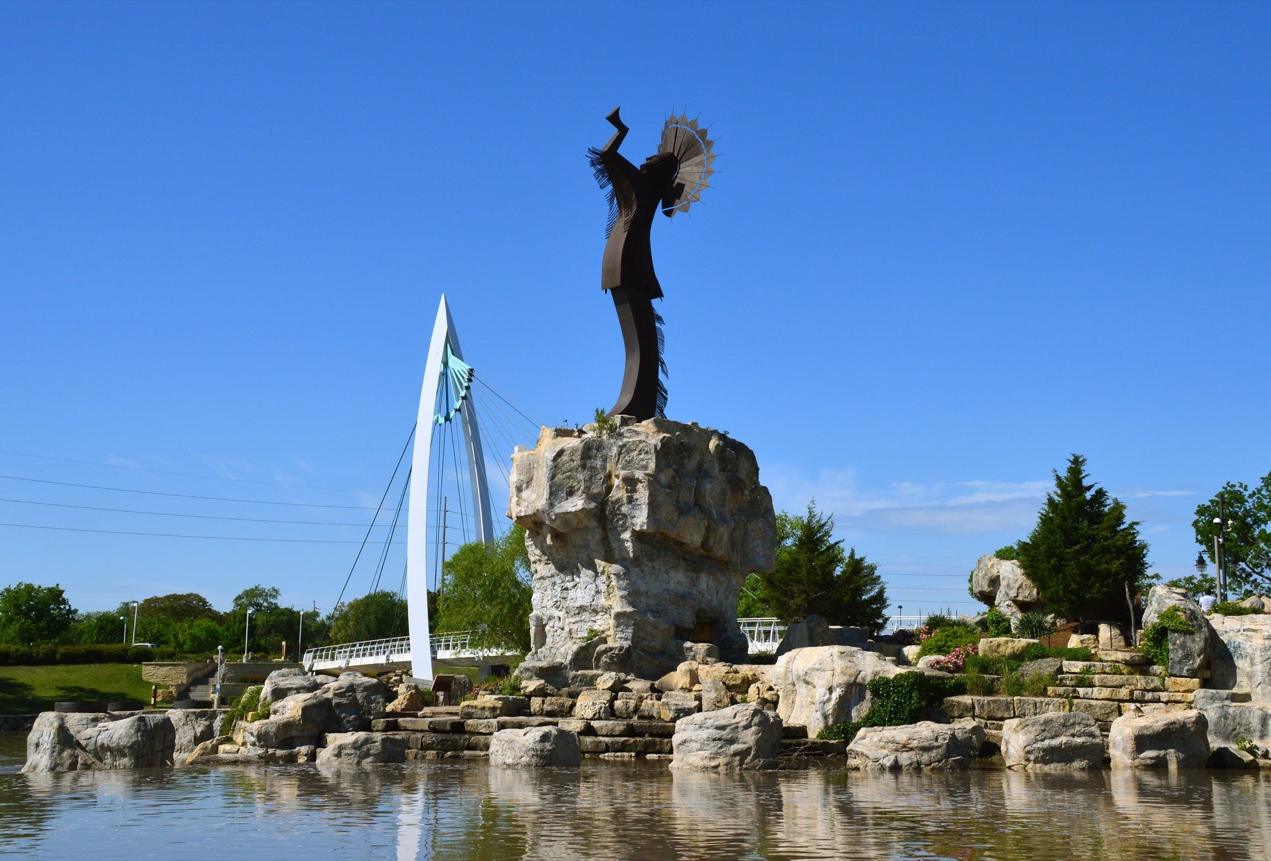 The Keeper of the Plains is a 44 ft Corten steel sculpture by Kiowa-Comanche artist Blackbear Bosin that stands at the confluence of the Arkansas and Little Arkansas rivers in Wichita, Kansas.