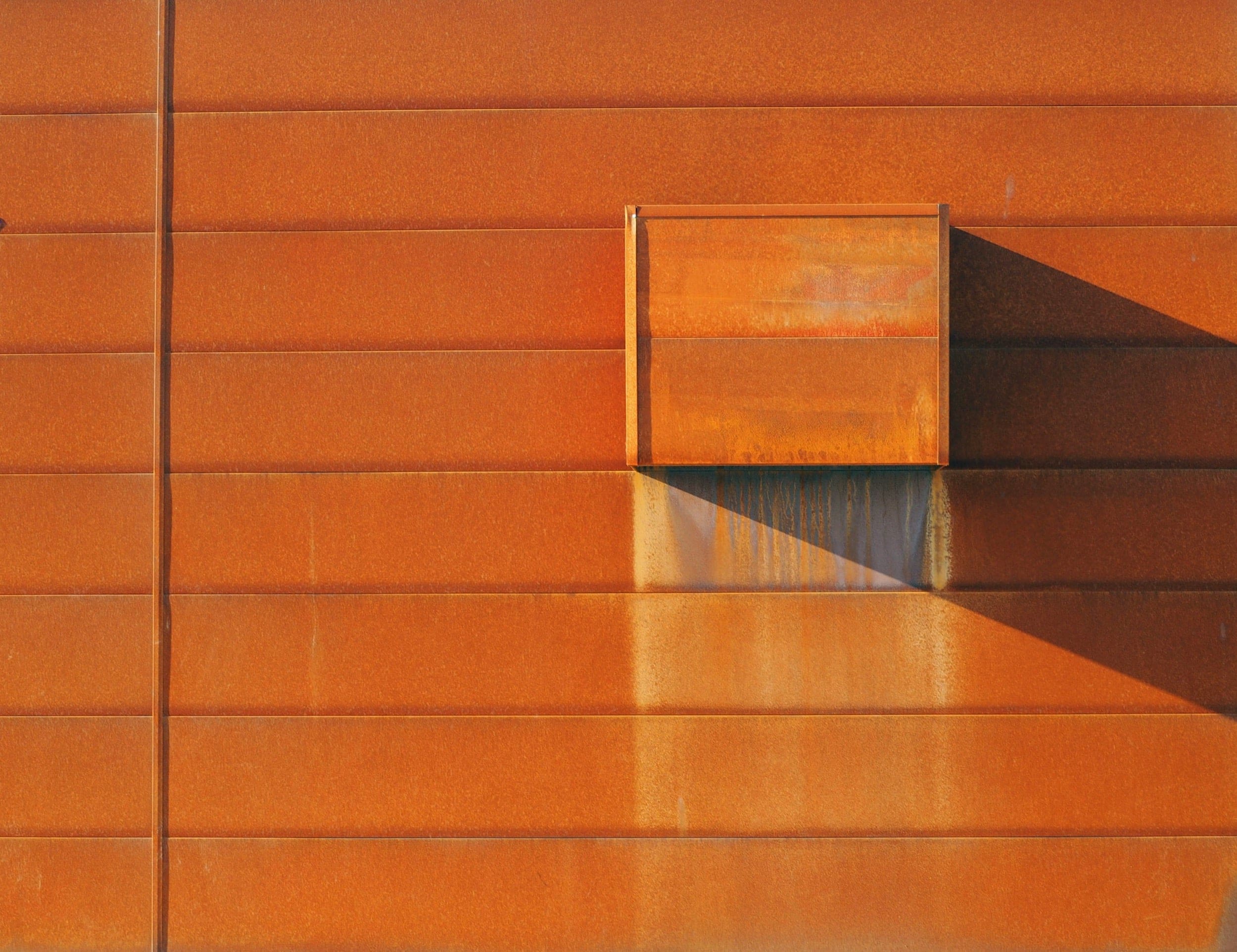 Facade penetrations and other elements can negatively impact weathering patterns on Corten steel.