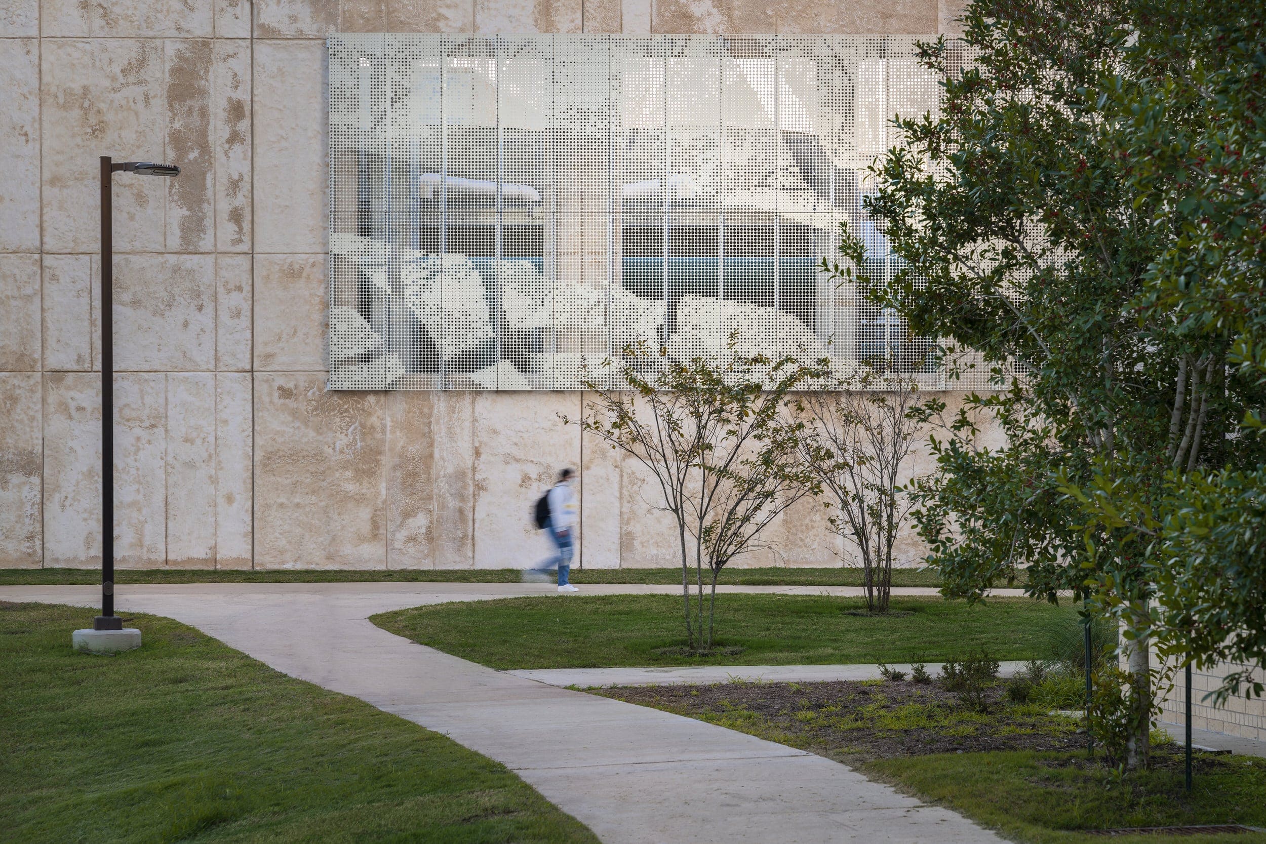 The tree canopy pattern on the ImageWall panels echoes the finish on the building facade and the landscaping nearby.