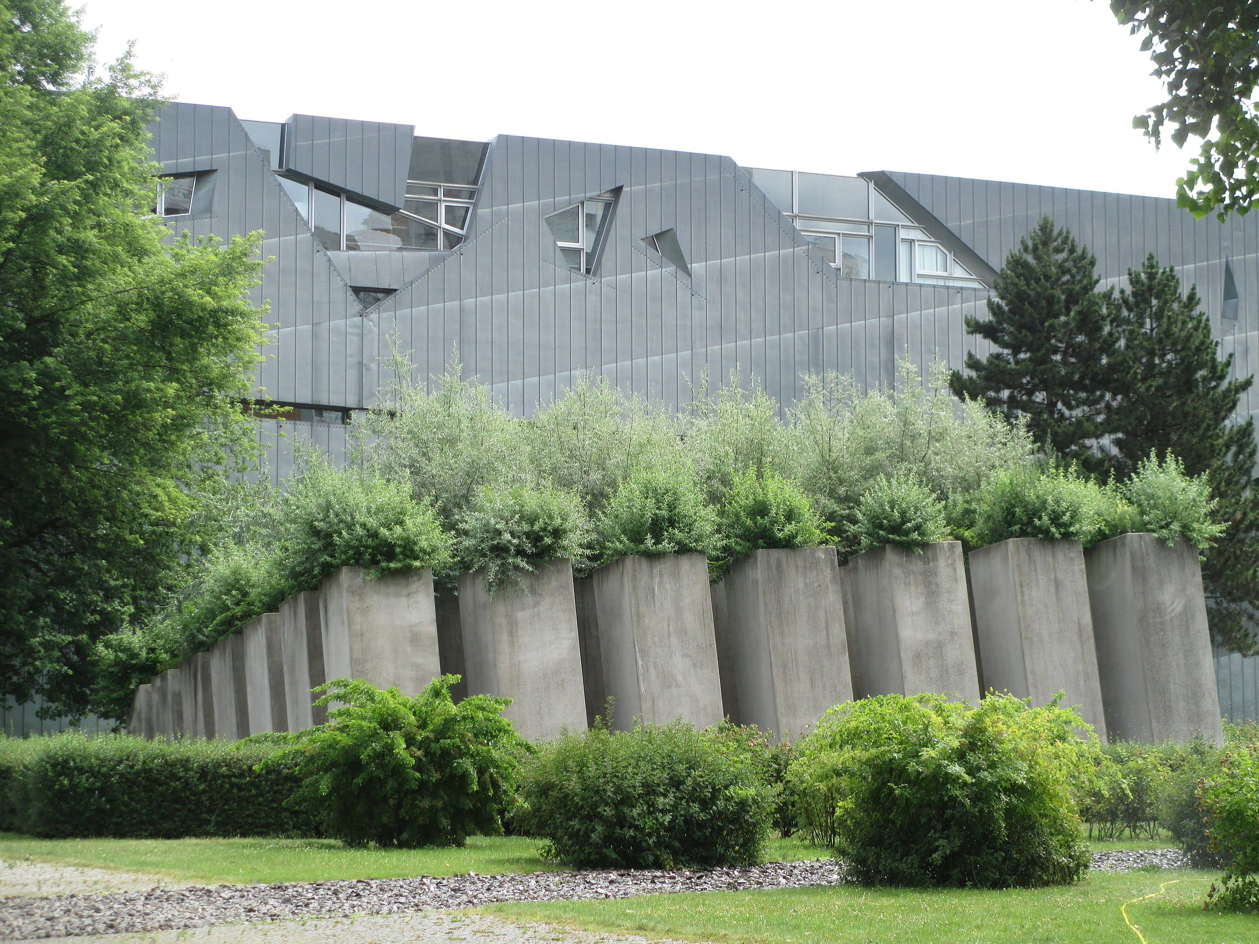 The zinc-clad Jewish Museum sits behind the Garden of Exile in Berlin, Germany.
