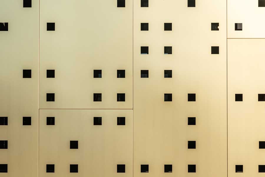 Square perforations in the Haas Moto Museum's facade.