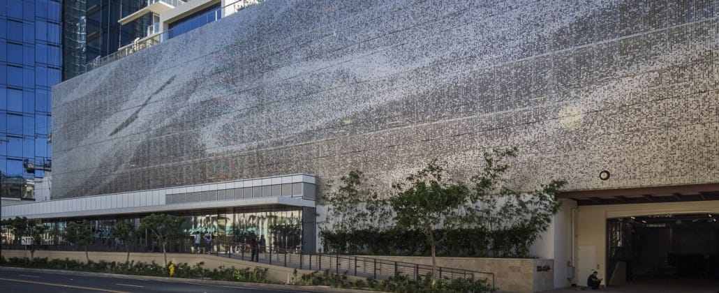 THE WAIEA BUILDING PARKING STRUCTURE IN HONOLULU, HAWAII FEATURES A PERFORATED PANEL FACADE .