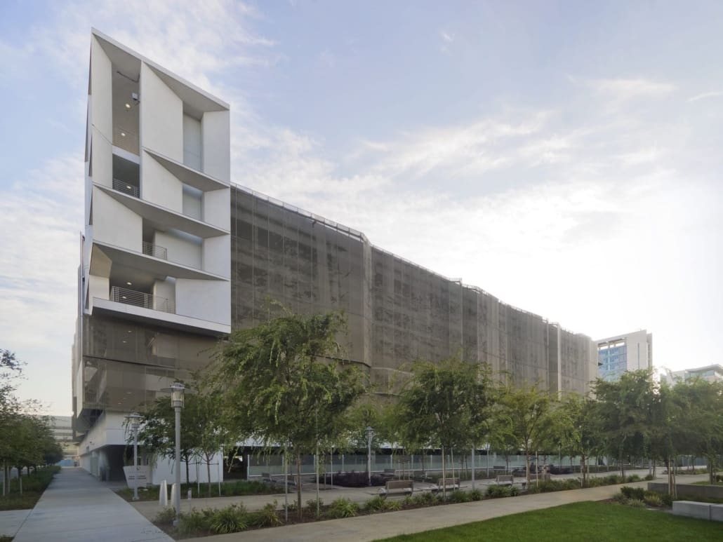 The Mission Bay Block 27 parking structure features a metal screen with perforated imagery of California’s redwood forests.